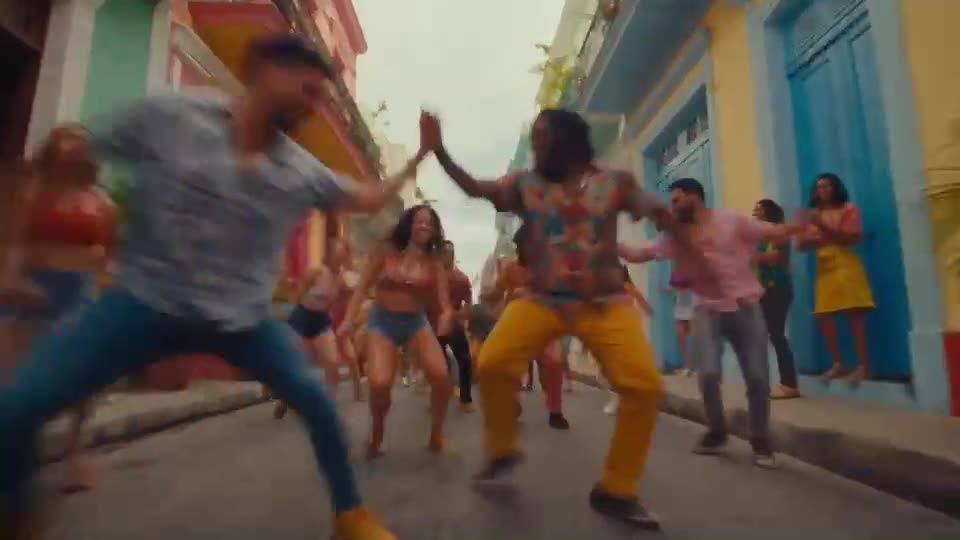 Dancers in a colorful street, in a Latin music video scene